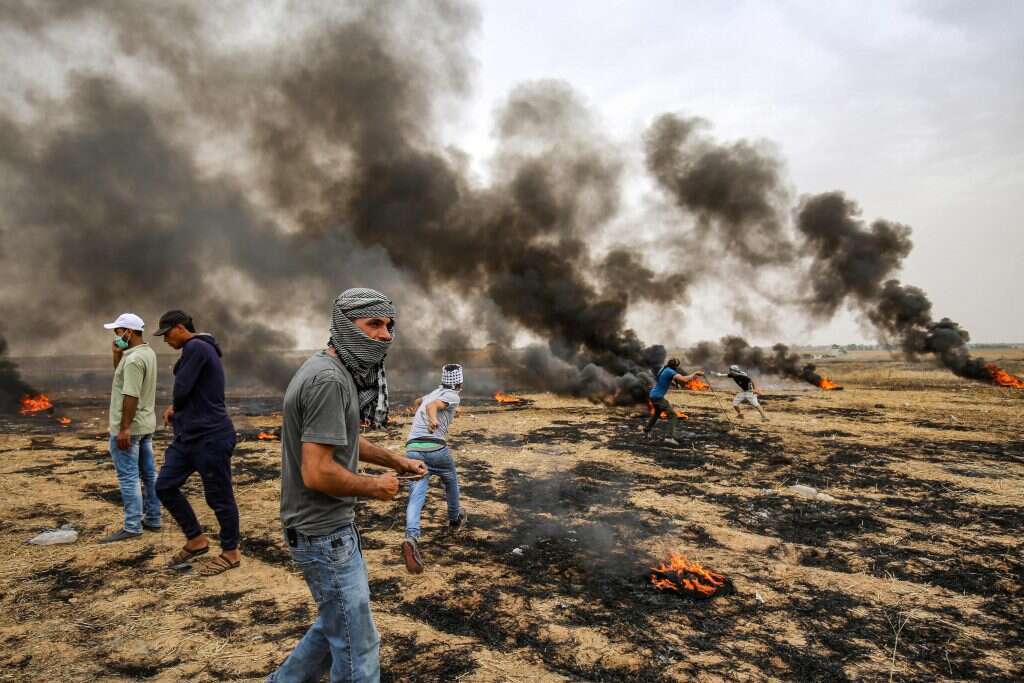 מתפרעים וכוחות צה"ל בגבול רצועת עזה. | AFP