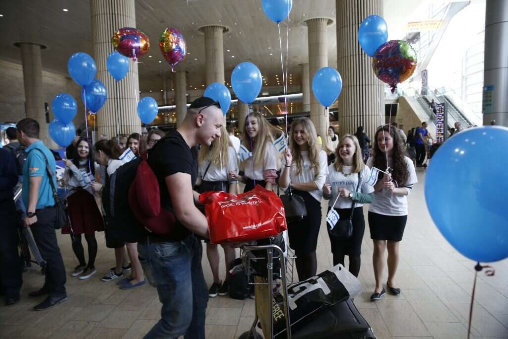 דמותו המחויכת של אקשטיין השקיפה מן השלטים בנתב"גץ עולים מאוקראינה נוחתים בישראל בסיוע הקרן לידידות. | באז רטנר