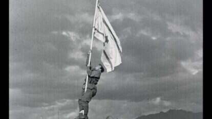 הנפת דגל הדיו באום רשרש, אילת. ב | החייל אברהם אדן (ברן) מטפס על עמוד כדי להניף את דגל הדיו אשר אולתר ע"י חיילי החטיבה, 1949 . הנפת דגל הדיו באום רשרש, אילת. ב | החייל אברהם אדן (ברן) מטפס על עמוד כדי להניף את דגל הדיו אשר אולתר ע"י חיילי החטיבה, 1949 .