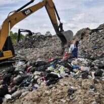 אספן אשפה המחפש פלסטיק למחזור באתר הטמנה בתאילנד. | AFP