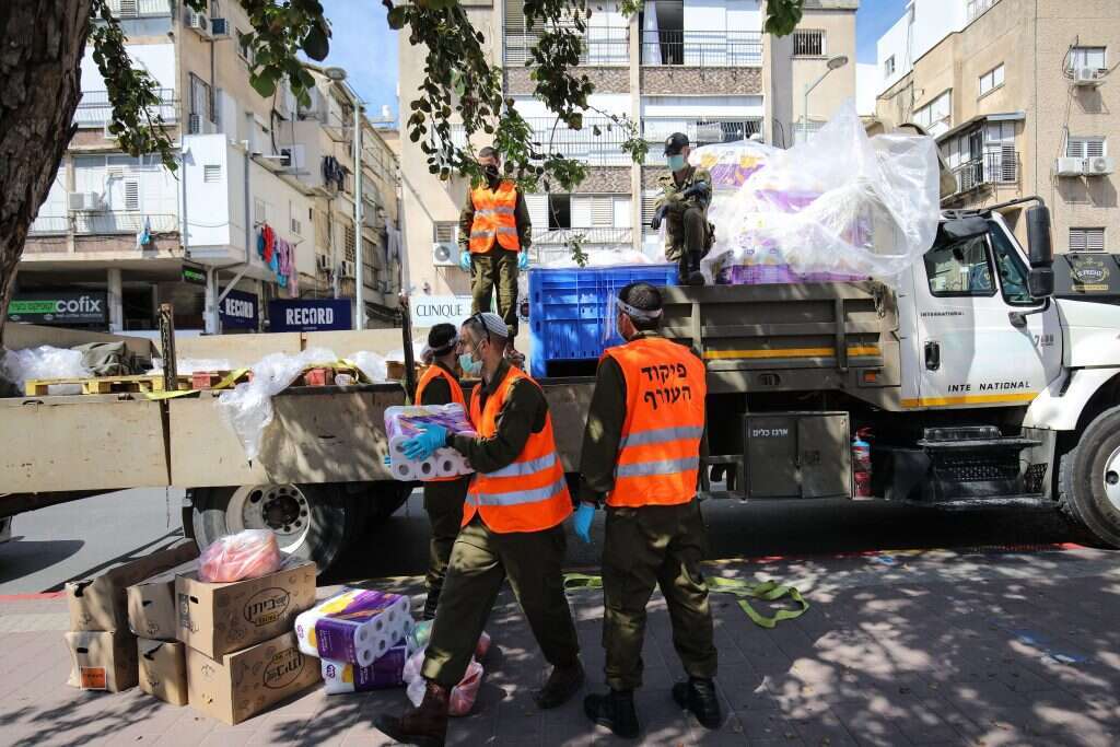 חיילים מחלקים מזון בבני־ברק בגל הראשון. | גטי אימג'ס