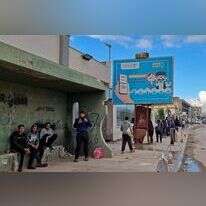 שלט בטריפולי הקורא להירשם כדי להשתתף בבחירות. | AFP