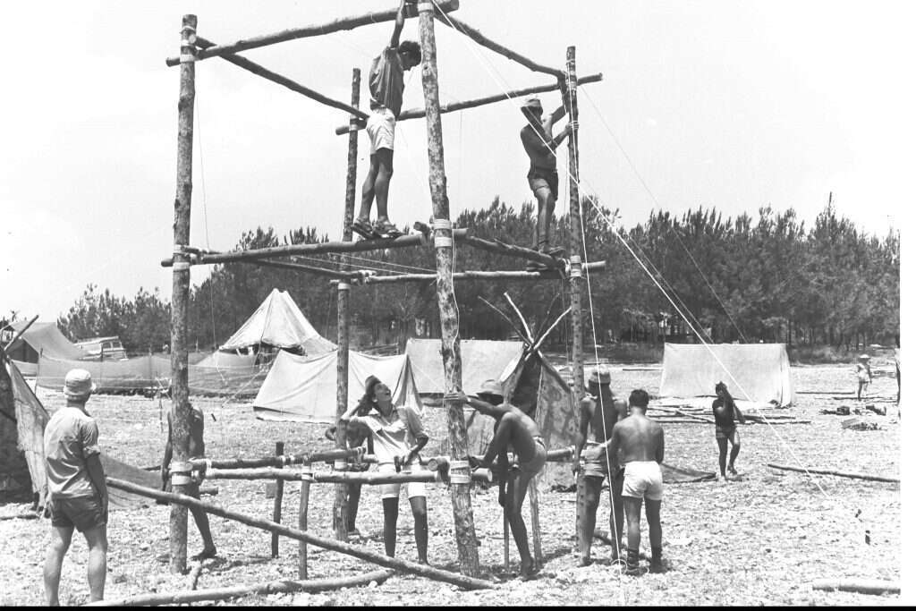 "כל הערכים באים ממקום של
תורה". צופי שבט בזק מנתניה בונים מגדל בג'מבורי הארצי בבן־שמן, 1969. | פריץ כהן, לע"מ