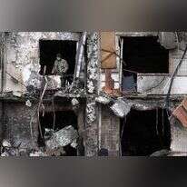 חייל אוקראינה עומד בבית הרוס במרכז קייב. | AFP