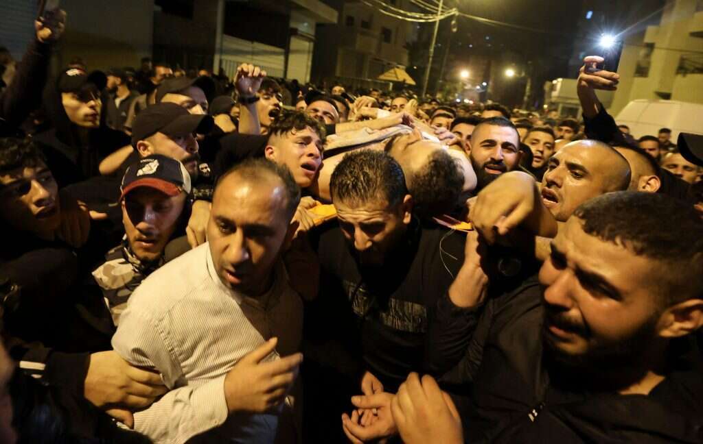 פלסטינים בשכם עם גופתו של מי שנחשב למנהיג "גוב האריות"'. | AFP פלסטינים בשכם עם גופתו של מי שנחשב למנהיג "גוב האריות"'. | AFP