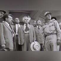 "נרכז קודם את העם בציון, נבטיח קיומו ושלומו, ובבוא הזמן יכריע במה שיש להכריע". בן־גוריון ממתין להגעת ארונו של הרצל, אוגוסט 1949. | סם דיאמונד, לע"מ