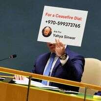 השלט שהרים גלעד ארדן בעת נאומו באו"ם. | AFP השלט שהרים גלעד ארדן בעת נאומו באו"ם. | AFP