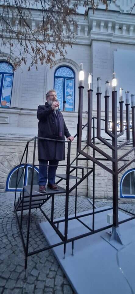 הרב בירנבוים מדליק נרות חנוכה בפתח בניין הקהילה היהודית בקישינב