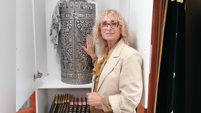 רחלי פריקר לצד ספר תורה בבית הכנסת בבארי