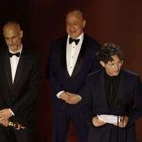 ג'ונתן גלייזר (מימין) נושא נאום נגד ישראל אחרי זכייה בסרט הבינלאומי הטוב ביותר. | EPA