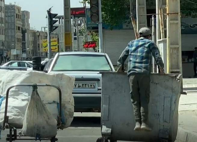 צעיר קופץ לפח כדי לחפש אוכל בטהראן. | מסך מיוטיוב