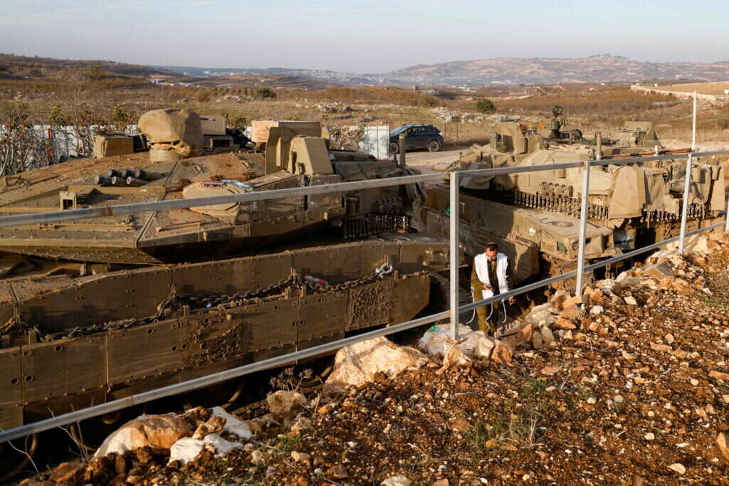 An Israeli soldier walks past tanks deployed near the Israel-Syria border in the Israel-annexed Golan Heights on December 8, 2024. Islamist-led rebels declared that they have taken Damascus in a lightning offensive on December 8, sending President Bashar al-Assad fleeing and ending five decades of Baath rule in Syria. (Photo by Jalaa MAREY / AFP) An Israeli soldier walks past tanks deployed near the Israel-Syria border in the Israel-annexed Golan Heights on December 8, 2024. Islamist-led rebels declared that they have taken Damascus in a lightning offensive on December 8, sending President Bashar al-Assad fleeing and ending five decades of Baath rule in Syria. (Photo by Jalaa MAREY / AFP)