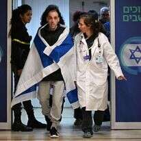 אליהו (אלי) שרעבי עטוף בדגל ישראל, עם הגעתו לבית החולים שיבא. | חיים צח /לע"מ