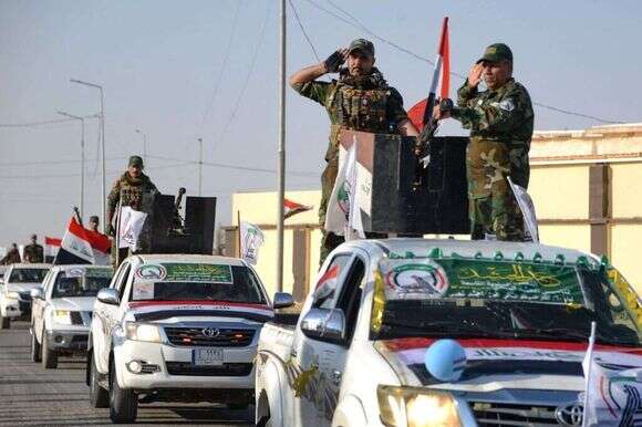מיליציות של "אל־חשד א־שעבי" בעיראק. | AFP מיליציות של "אל־חשד א־שעבי" בעיראק. | AFP