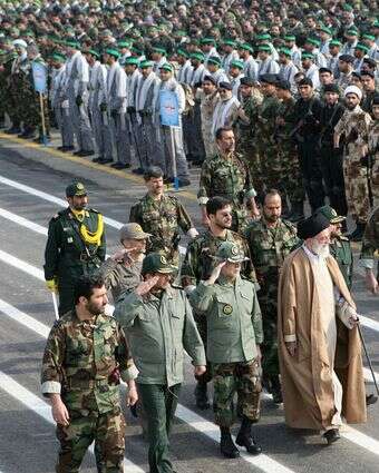 המנהיג העליון של איראן, אייתוללה עלי חמינאי, הולך עם מפקדים איראנים ליד אנשי מיליציית הבסיג' בטהרן | AFP