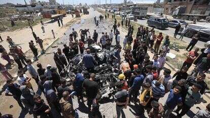 עזתים בוחנים רכב של פעילי חמאס שהותקף אתמול במחנה אלבוריג' | AFP