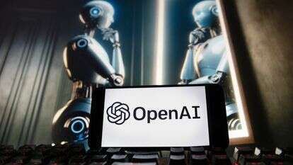 הלוגו של OpenAI מוצג בטלפון סלולרי עם תמונה על צג מחשב - שנוצרה על ידי מודל הטקסט-לתמונה של Dall-E | AP