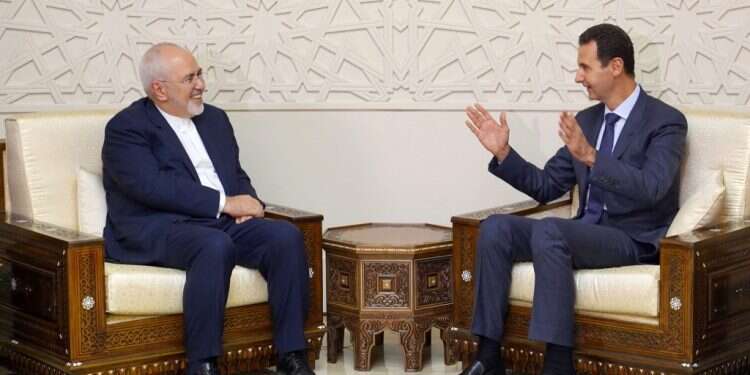 שר החוץ האיראני זריף עם נשיא סוריה אסד. צילום: AFP צילום: AFP