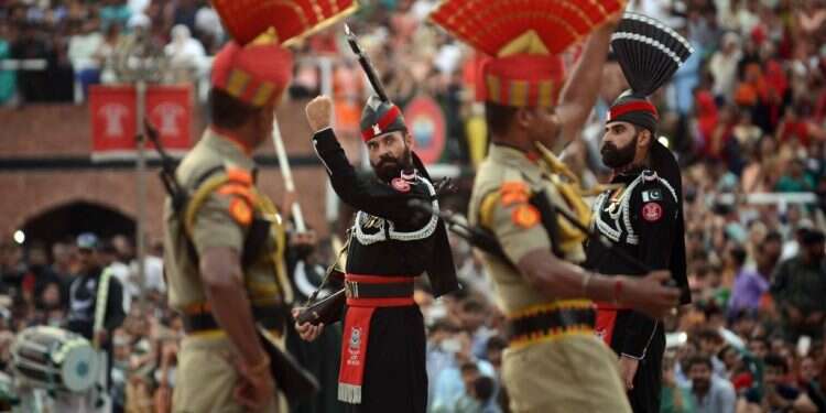 טקס סגירת הגבול בין הודו (בחום) לפקיסטן (בשחור), המתרחש בכל יום. צילום: AFP צילום: AFP