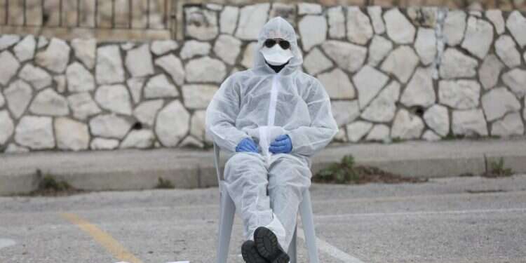 ישראלי בחליפת בידוד. צילום: EPA לא מצורעים: מה לעשות אם חבר או קרוב נכנס לבידוד?