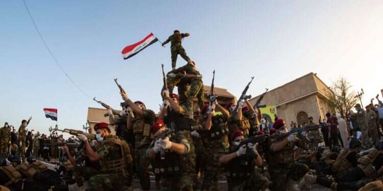 מליציה עיראקית חוגגת שש שנים להקמתה למאבק בדאעש. צילום: AFP מלאך המוות ואני: האם עיראק תעמיד לדין מנהיג שסרח?