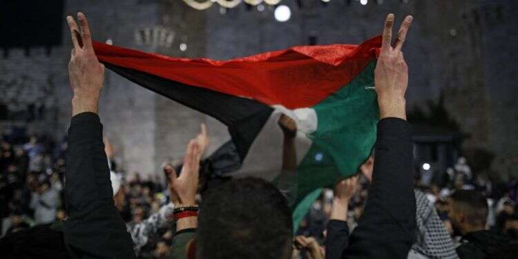 דגל הרשות הפלסטינית מונף בשער שכם. צילום: AFP "יהודים וערבים יכולים לחיות יחד בירושלים, אבל חייבים פתרון פוליטי"