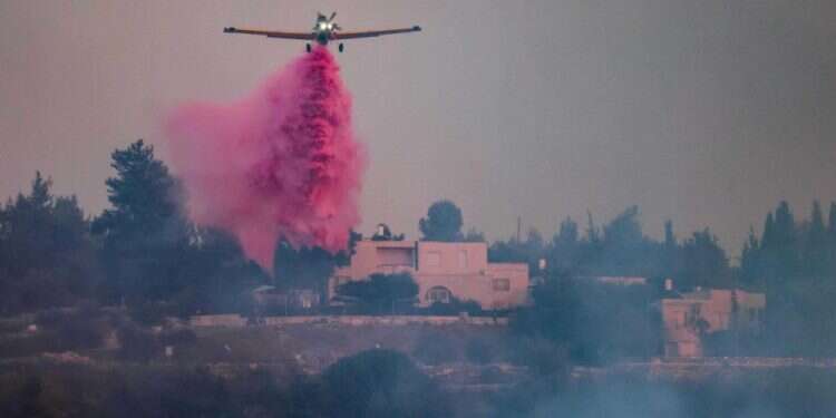 מטוסי הכיבוי מאחד אחד היישובים. צילום: AFP האש ממשיכה לבעור בהרי ירושלים, 17,000 דונם נשרפו
