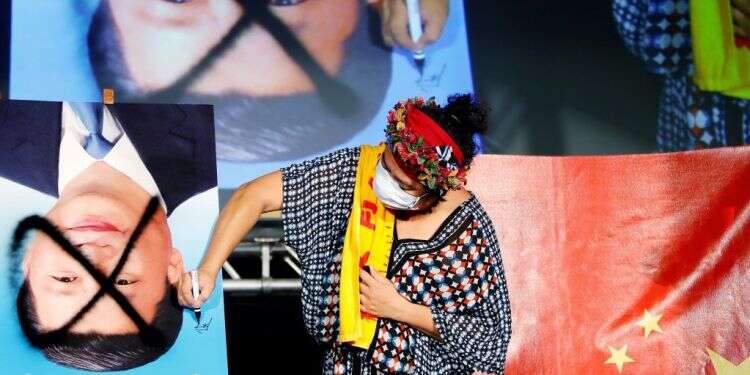 הפגנה נגד המפלגה הקומוניסטית הסינית בטאיוואן. צילום: EPA דו"ח חדש: סין מבצעת רצח עם באוכלוסייה האויגורית