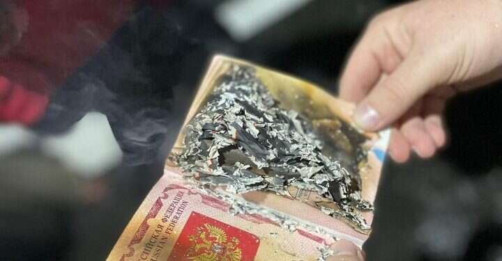 דרכונים נשרפים מול השגרירות הרוסית בתל אביב, הערב. צילום: אודי שחם "הגענו לכאן כדי למחות נגד המלחמה שפוטין מנהל"