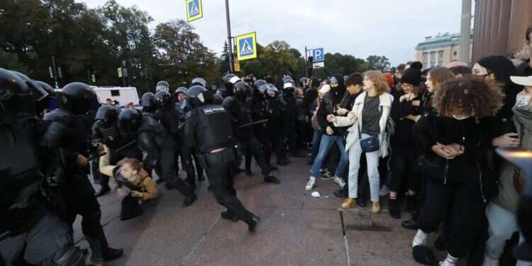 שוטרים רוסים מעכבים מפגין במחאה בלתי חוקית נגד הגיוס החלקי, בסנט־פטרבורג. צילום: AFP הגיוס ברוסיה ו"משאלי" הסיפוח משנים את נרטיב המלחמה במוסקבה