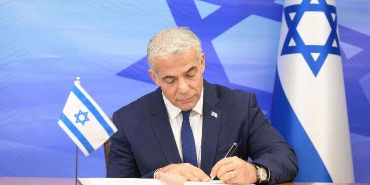 ראש הממשלה יאיר לפיד חותם על ההסכם עם לבנון. צילום: עמוס בן גרשום, לע "ההישגים" של לפיד בהסכם עם לבנון הם למעשה כניעה מפוארת