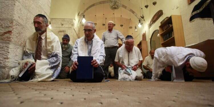 יהודים קראים משתטחים בתפילה בבית הכנסת הקראי בעיר העתיקה בירושלים, 2011. צילום: אורי לנץ, פלאש 90