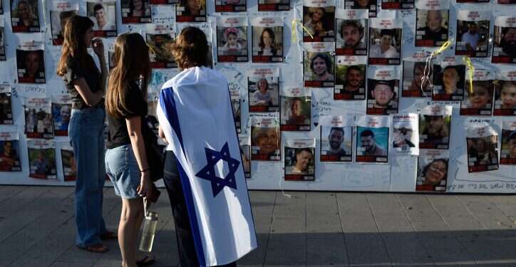 נערה עטופה בדגל ישראל ב- נערה עטופה בדגל ישראל ב-"כיכר החטופים". צילום: גיל יערי, פלאש 90