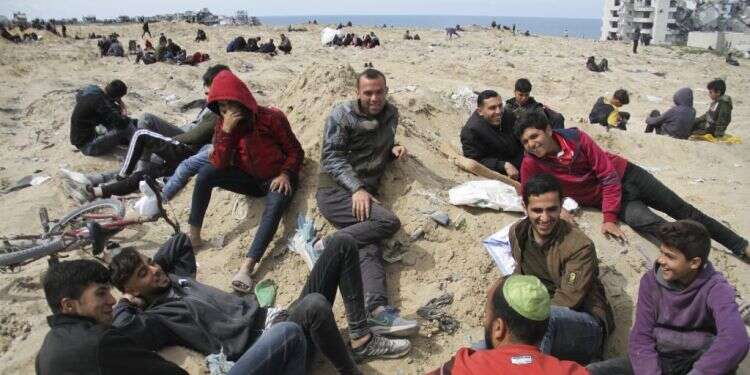 פלסטינים בחוף הים בעזה, בשבת. צילום: Mahmoud Essa, AP מחקר בארה"ב: כך מזייף חמאס את מספרי ההרוגים בעזה