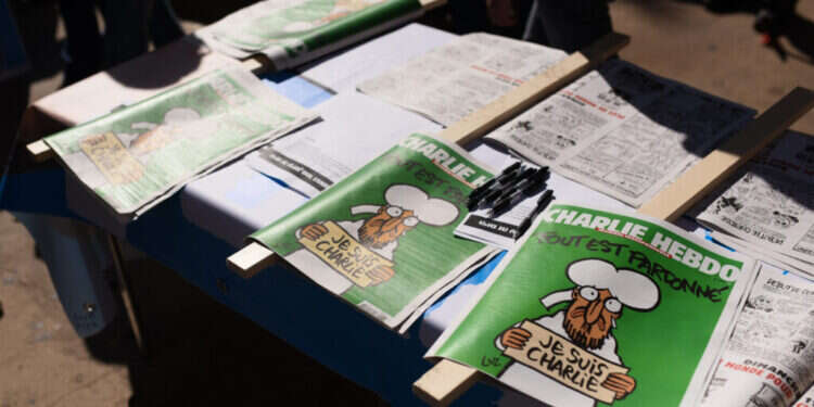 The latest edition of the satirical weekly newspaper Charlie Hebdo during a protest in support of the latest edition of the satirical weekly newspaper Charlie Hebdo in Tel Aviv on February 5, 2015, The Israeli election committee forbidden Yisrael Beytenu political party to distribute any gifts or free merchandise to the public in such proximity to the elections including the latest edition of Charlie Hebdo. Photo by Ben Kelmer/Flash90
*** Local Caption *** àáéâãåø ìéáøîï
éùøàì áéúðå
îôìâä
äôâðä
öòéøé éùøàì áéúðå
ùàøìé äáãå
òéúåï
öøôú "צרפת התחמשה, אך האיום עדיין קיים": עשור לפיגוע ב"שארלי הבדו"