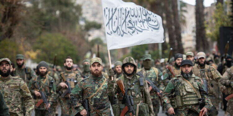 כוחות היאת תחריר א-שאם בדמשק ובידם דגל הטאליבן. צילום: EPA מבחן המציאות: אל-ג'ולאני לא באמת שולט בסוריה